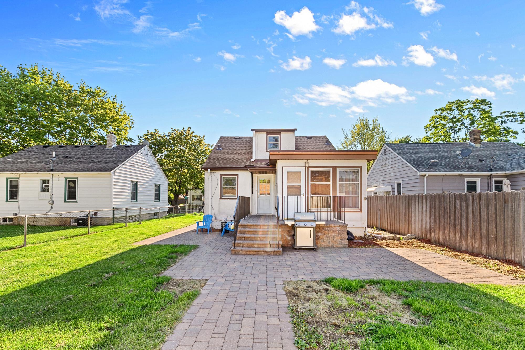 The inviting brick sidewalks, patio and the yard grading with underground drainage was done by the local Simons Landscaping in 2019. The custom railing was done by the local Krech Ironworks.