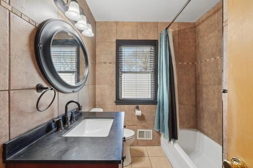 Fully tiled bathroom from floor to ceiling