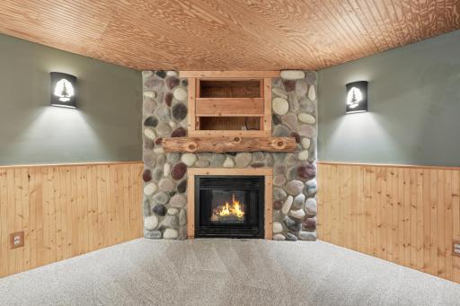 Stone fireplace and warm wood tones; this is where people gather