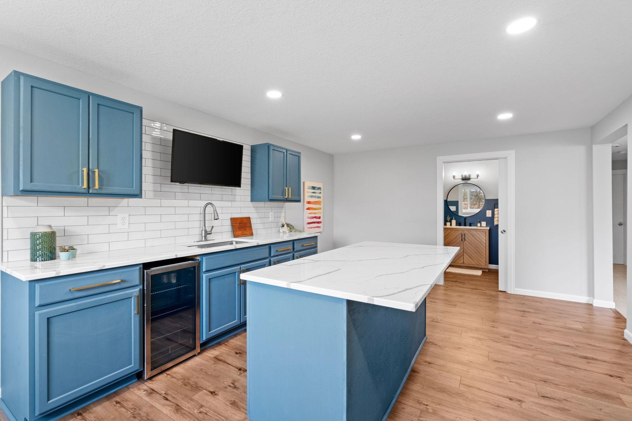 Stainless steel appliances and a center island for this stunning open kitchen.