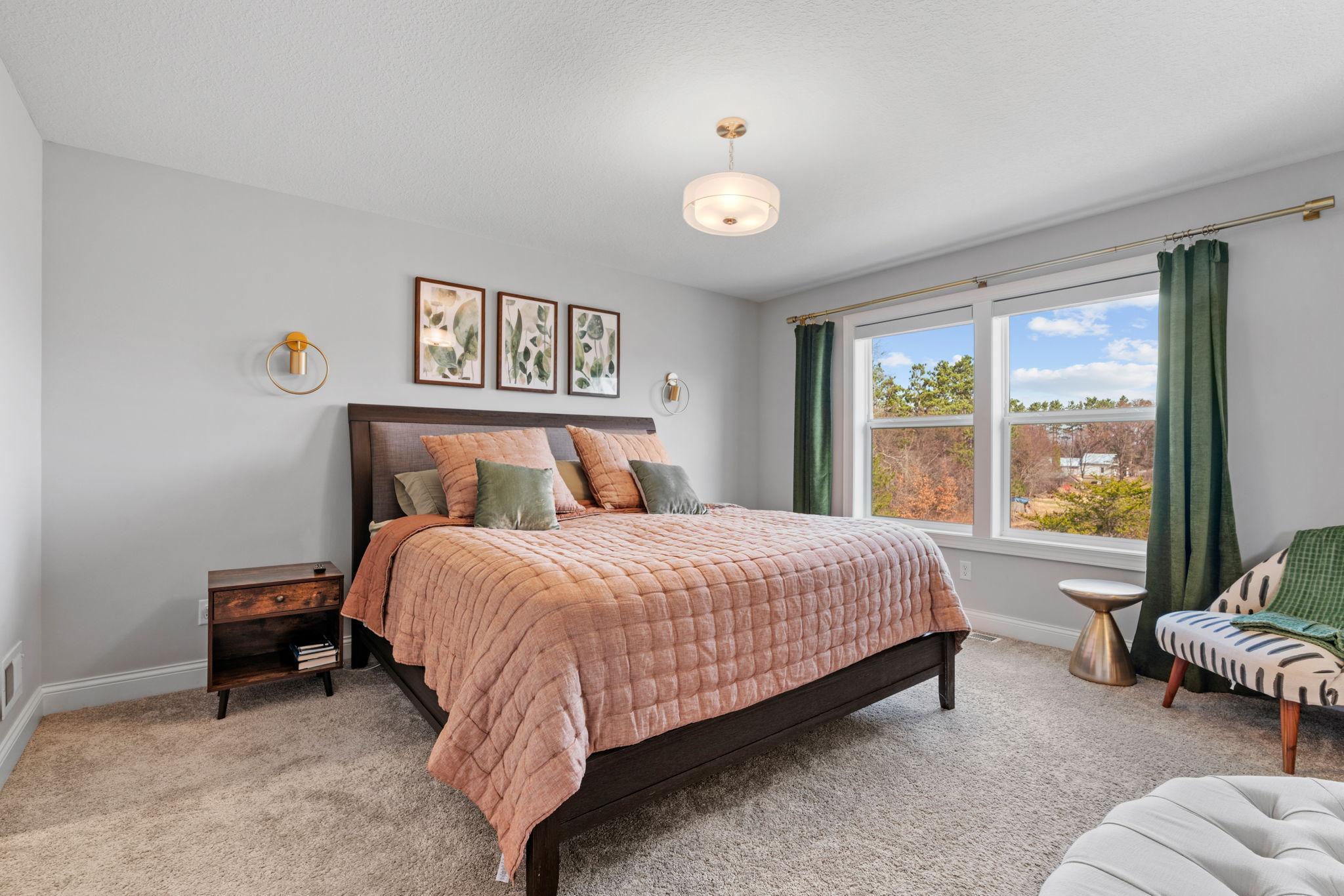 The primary suite overlooks the picturesque rear landscape.