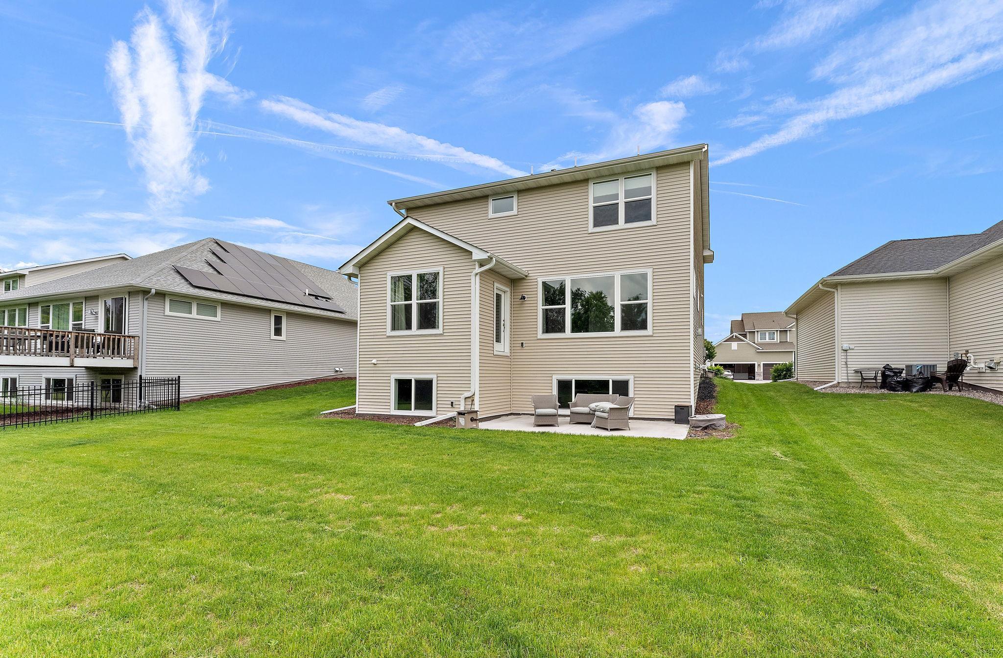 Beautiful rear patio overlooking a pristine flat yard.