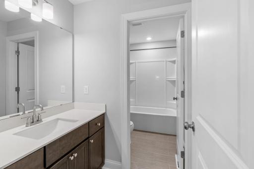 Upper level full bathroom with separated toilet and shower.