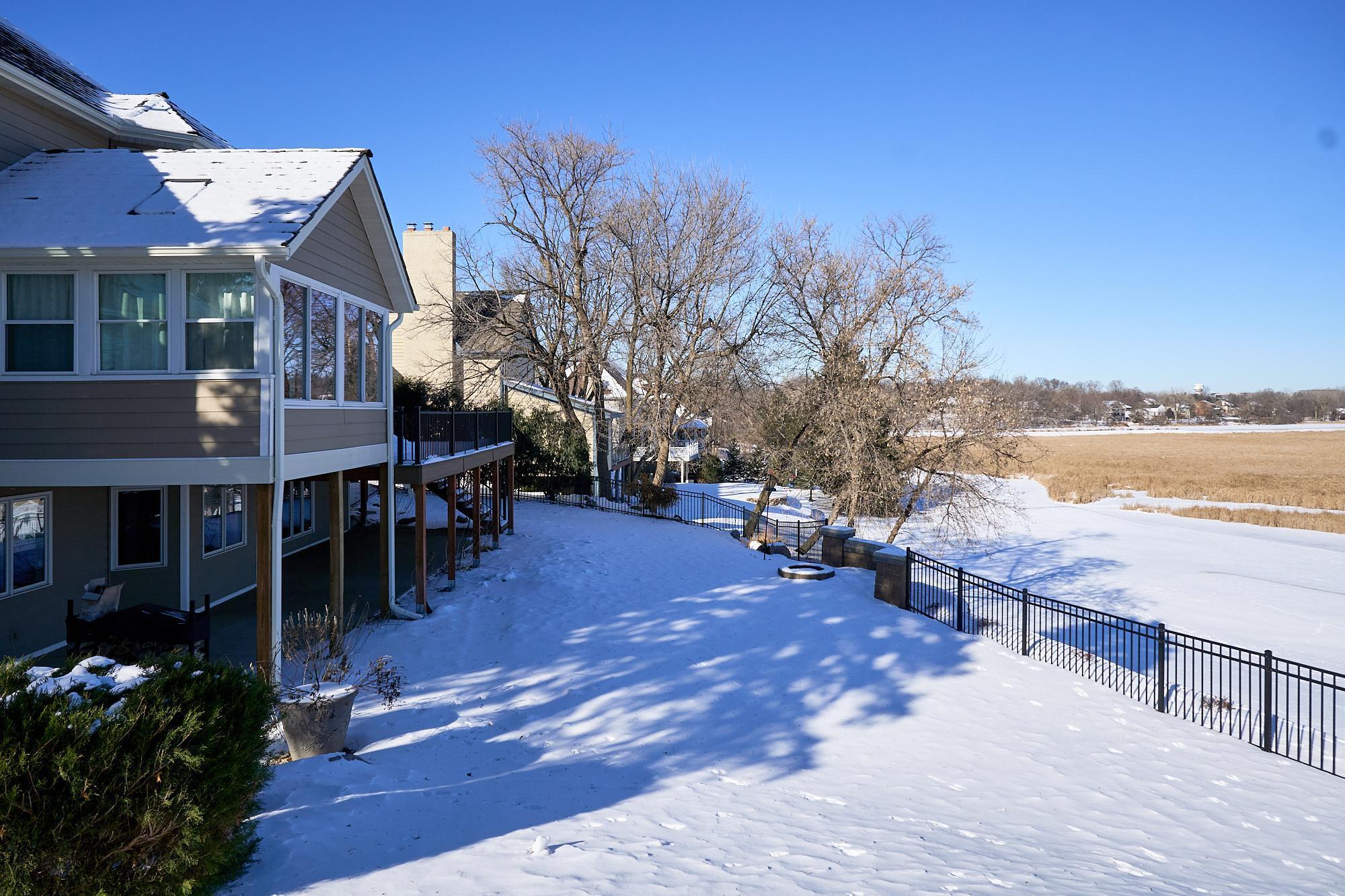 Fully fenced yard & stone firepit overlooking panoramic view of the golf course & the nature preserve. Stone steps lead down to the 6th tee box.