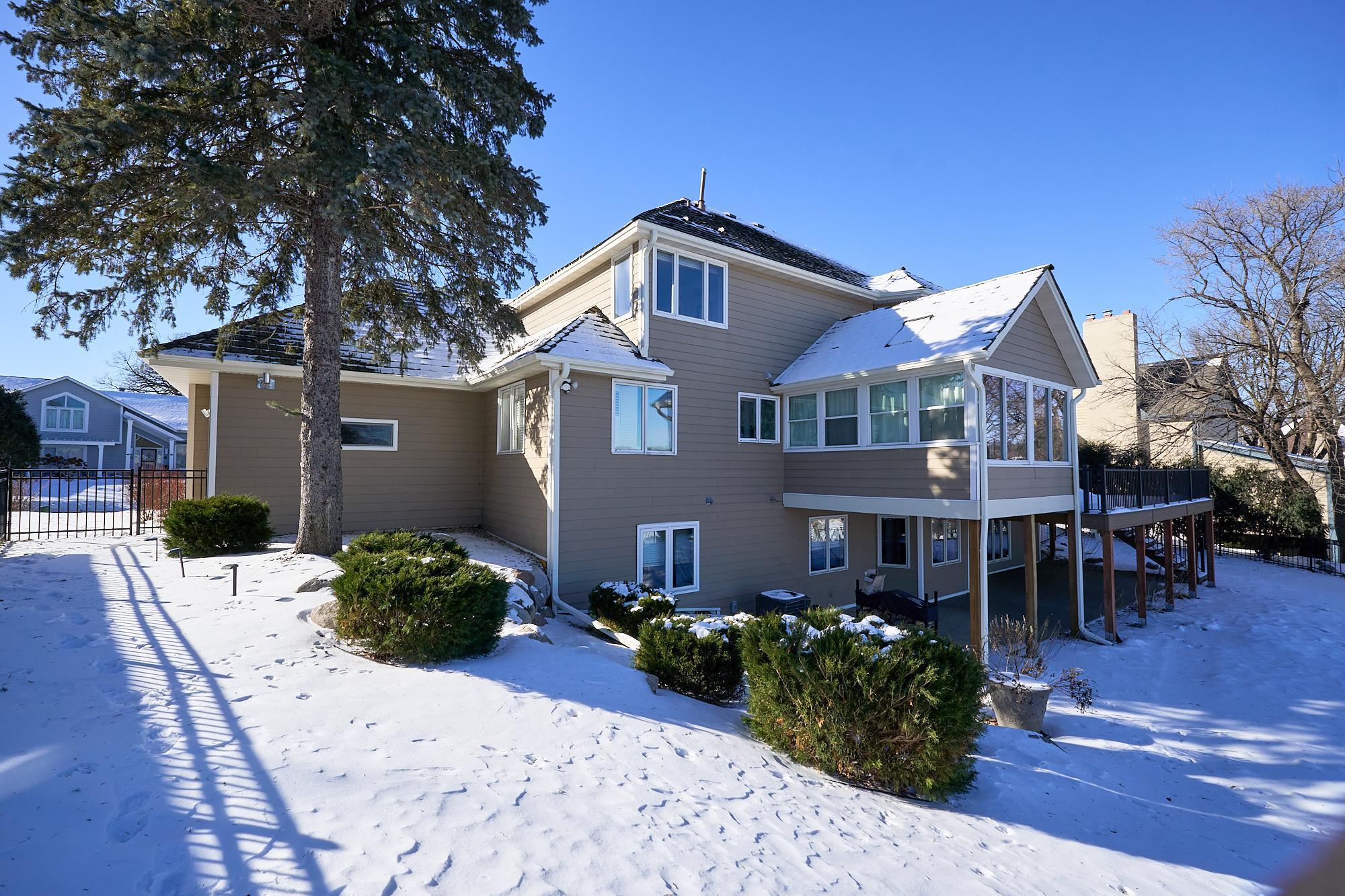 Professionally landscaped, 3-season porch, new Trex deck, walkout to patio, and so much more!