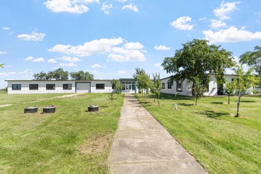 Guest House Has 4 More Bedrooms, similar condition. Left side of property is large, open garage style room