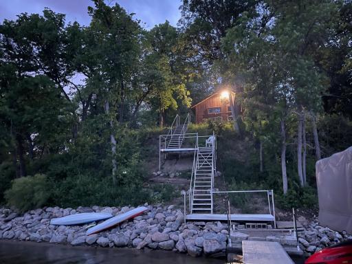Enjoy 168 ft of shoreline for all your lake toys plus a beautiful hilltop cabin nestled in the trees overlooking the lake and sunsets.