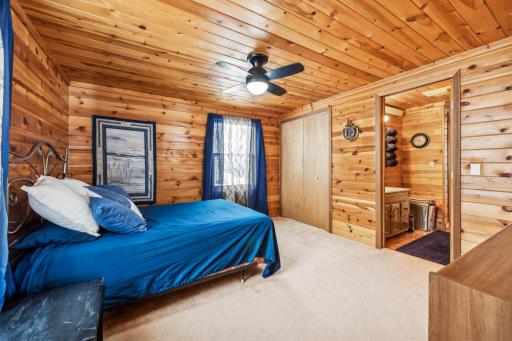 This cozy bedroom exudes rustic charm with its warm knotty pine walls & ceiling. A spacious closet offers ample storage, and the attached bath add convenience. This is the perfect retreat after a long day on the lake!
