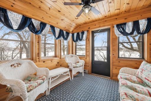 The charming all-season porch is the perfect spot to unwind in the evening or serve as a convenient entrance and drop zone for your lake toys.