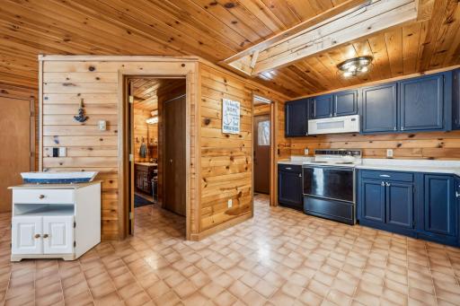 The full-sized bath features a tub and shower, perfect for cleaning up after a day on the lake. It also serves as a convenient walkthrough to the primary bedroom on the main level.