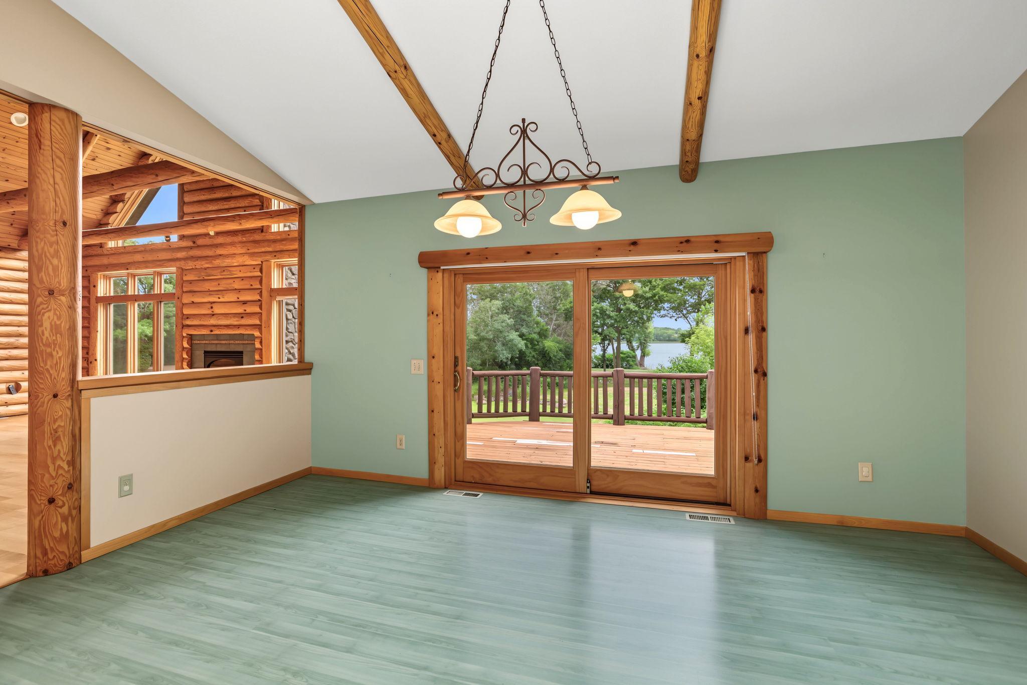 Filled with natural light, the informal dining area opens to the expansive deck through sliding glass doors, creating the perfect backdrop for indoor-outdoor entertaining and beautiful lake views.