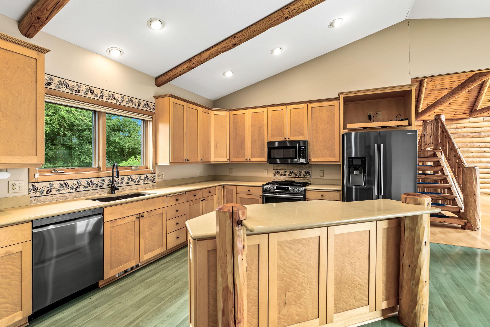 The heart of the home, this spacious kitchen offers maple cabinetry, Silestone countertops, center island, and abundant workspace.