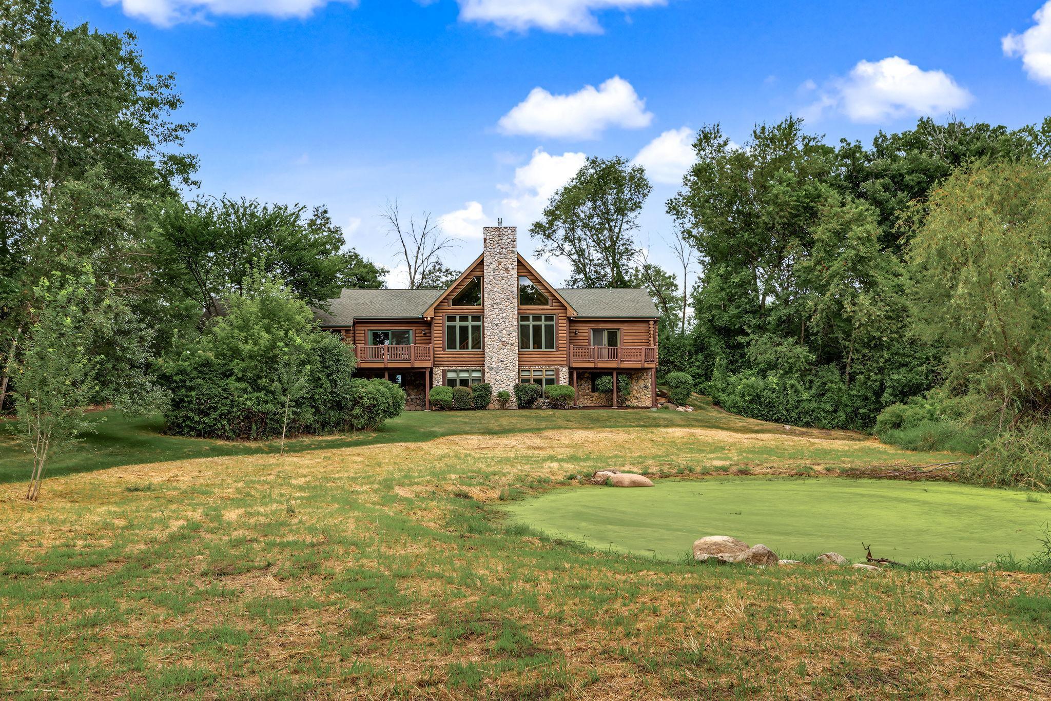 Mature trees provide privacy while the level lawn offers plenty of room for entertaining, outdoor games, or relaxing around the fire pit.