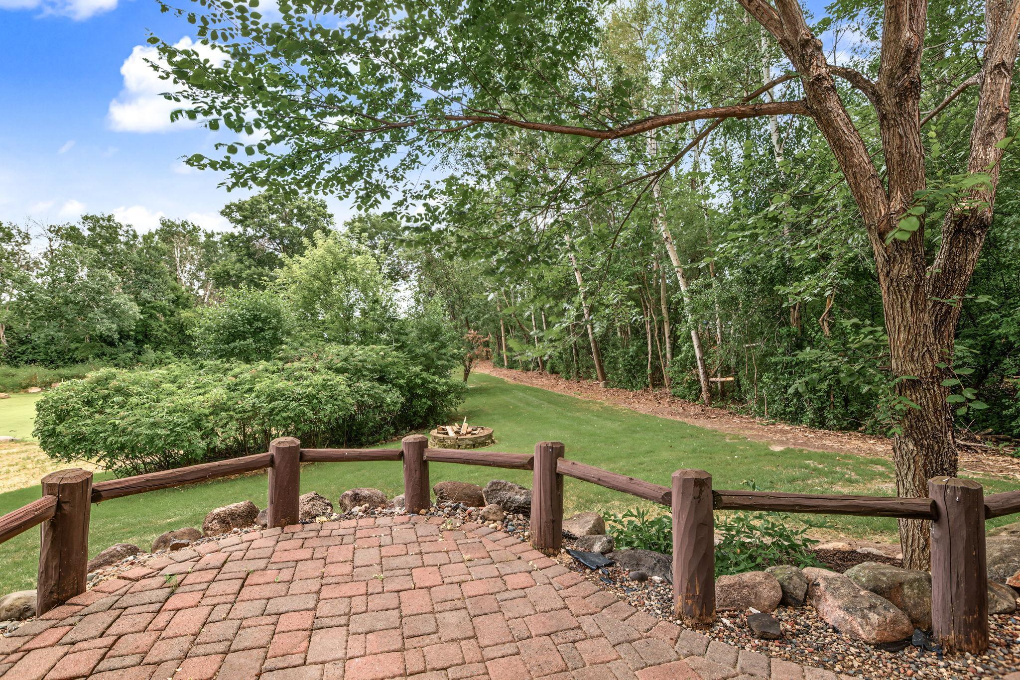 Step outside and enjoy your own private backyard retreat. The spacious paver patio provides the perfect setting for outdoor dining, entertaining, or simply relaxing while surrounded by mature trees.