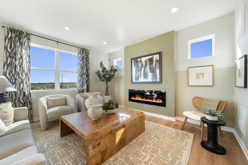 Welcome home to the Sophia Floorplan by M/I Homes! Bright living room is perfect for unwinding after a long day! Elevate the ambiance with different rock/flame colors on your electric fireplace.