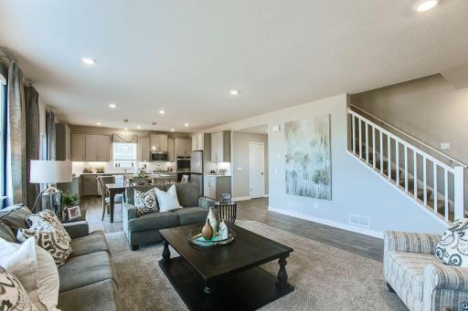 Open main level but actual home has upgraded hard floors in the living room. *Photos of a similar home. Colors and options will vary.
