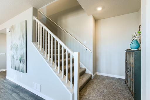 Wide staircase to the upper level. *Photos of a similar home. Colors and options will vary.