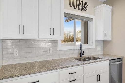 Granite countertops in kitchen with beautiful white cabinets