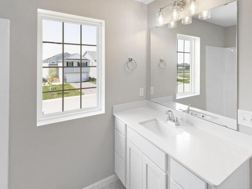 Photo of a different home with similar finishes and plan. Primary Suite Private Bath.