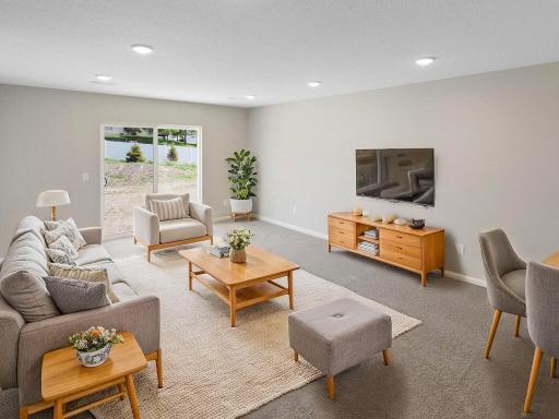 Virtually staged photo of a different home with similar finishes and plan. Lower Level Family Room.