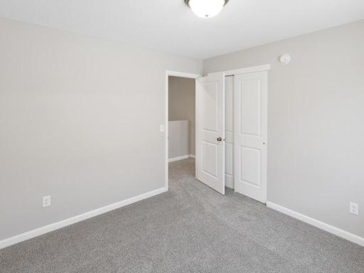 Photo of a different home with similar finishes and plan. Bedroom 2.