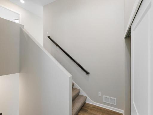 Photo of a different home with similar finishes and plan. Foyer view to the staircase.