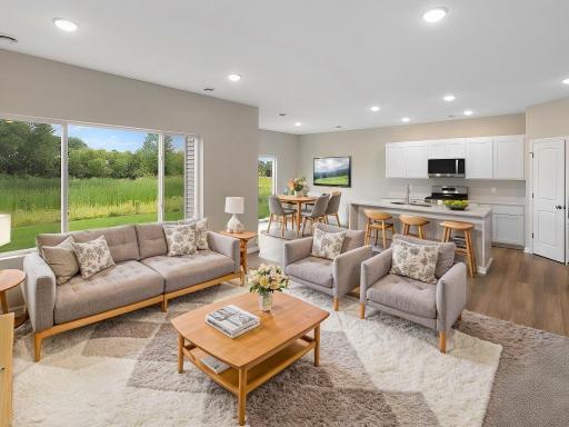 Virtually staged photo of a different home with similar finishes and plan. Great Room.