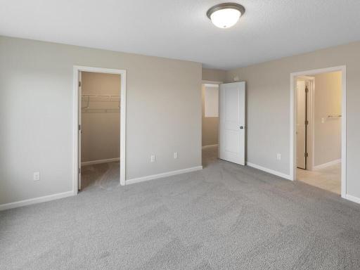 Photo of a different home with similar finishes and plan. Primary Suite.