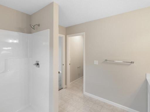 Photo of a different home with similar finishes and plan. Primary Suite Private Bath.