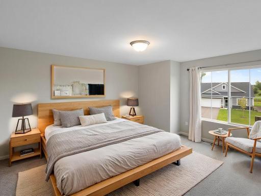 Virtually staged photo of a different home with similar finishes and plan. Primary Suite.