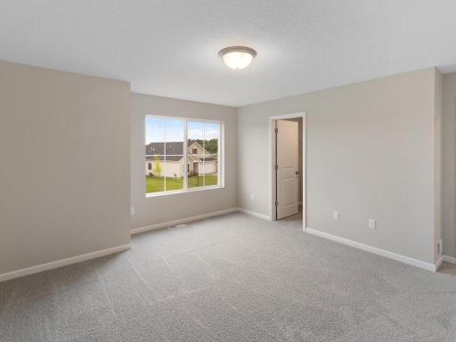 Photo of a different home with similar finishes and plan. Primary Suite.