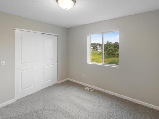 Photo of a different home with similar finishes and plan. Bedroom 3.