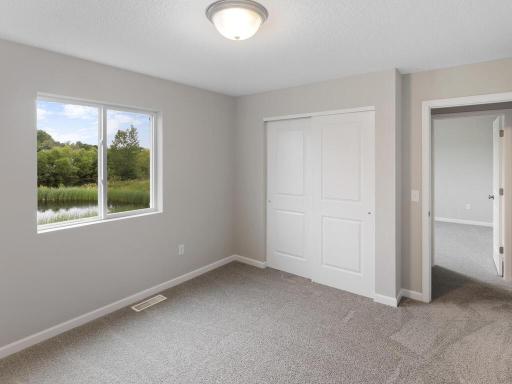 Photo of a different home with similar finishes and plan. Bedroom 2.