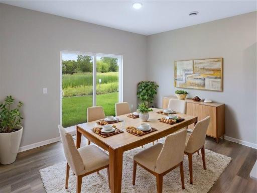 Virtually staged photo of a different home with similar finishes and plan. Dining Room.