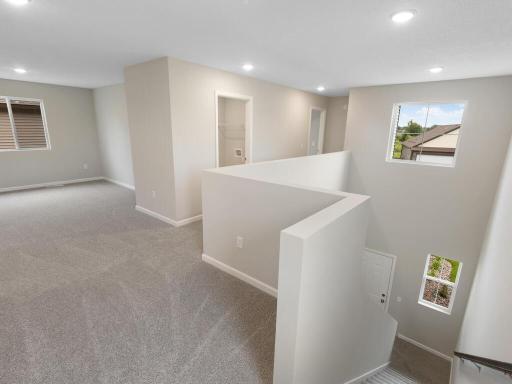 Upper Level Landing. Photo taken of another home with similar plan and finishes. Photos and renderings may not depict actual plan, materials, & finishes may vary. All measurements are approximate.