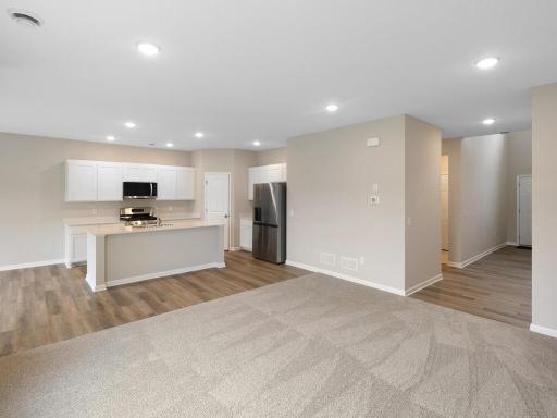 Open Concept. Photo taken of another home with similar plan and finishes. Photos and renderings may not depict actual plan, materials, & finishes may vary. All measurements are approximate.