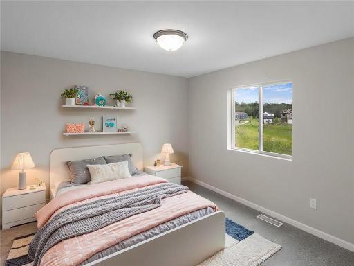 Bedroom 2. Virtually Staged. Photo taken of another home with similar plan and finishes. Photos and renderings may not depict actual plan, materials, & finishes may vary. All measurements are approximate.