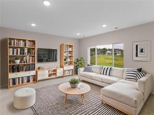 Living Room. Virtually Staged. Photo taken of another home with similar plan and finishes. Photos and renderings may not depict actual plan, materials, & finishes may vary. All measurements are approximate.