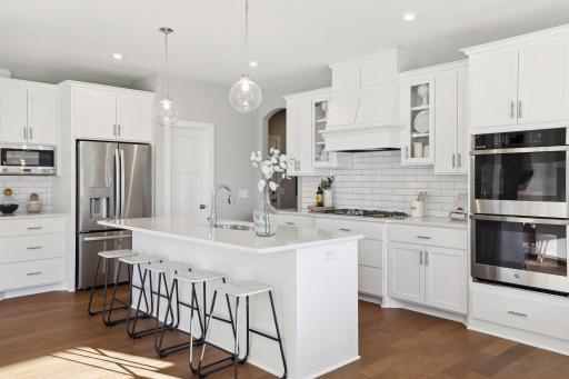 Our gourmet kitchen defines how the WOW comes standard. With a huge center island, granite countertops, gas cook top, and double ovens, plus so much more! (Pic of a previous model)