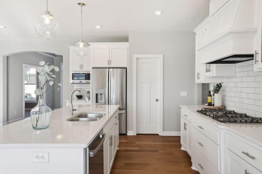 All our features are standard including the granite countertops, tile backsplash and under mount kitchen sinks. (Pic of a previous model)