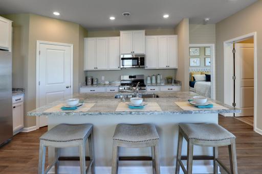 The kitchen features TONS of cabinets, a large island, and a corner pantry! *Pictures are of model home, colors and finishes may vary. *