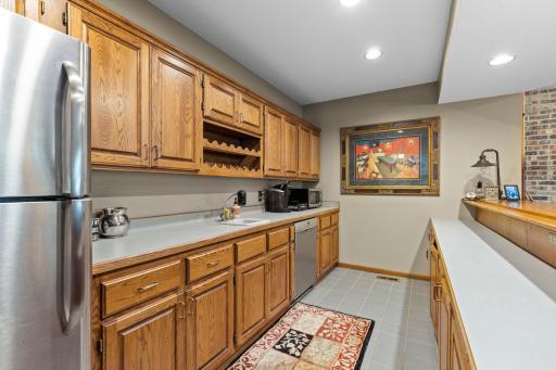 Wet Bar features dishwasher, microwave and refrigerator. Abundance of cabinets for storage!