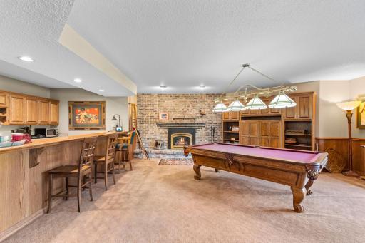 Fireplace w/ brick surround and built-in cabinets for extra storage