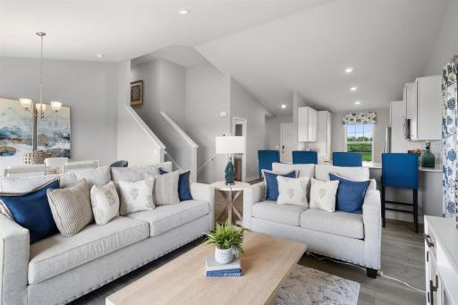 Spacious living room area highlighted with vaulted ceilings. Model home photo, actual home will vary in finishes.