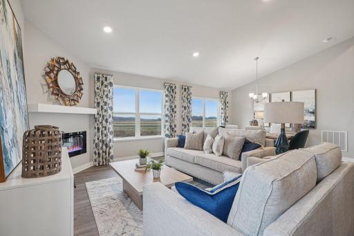 The main level family room is one of two similar living spaces in the home - both set up perfectly to meet all of your living needs! Model home photo, actual home will vary in finishes.