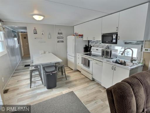 The kitchen has been recently updated with newer floor, newer appliances and kitchen island.