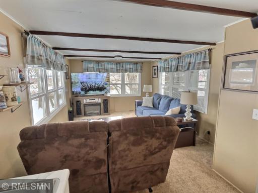 This living room offers a great view to the marina and has plenty of space for people to gather.