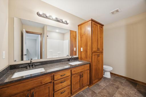 Additional bathroom offering granite countertop, quality cabinetry, and easy-to-maintain flooring.