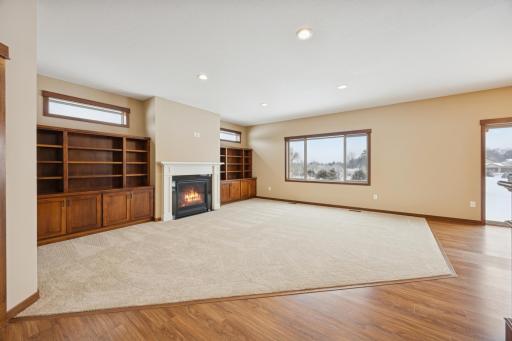 Another view of the living room showcasing the open layout, fresh neutral finishes, and all new carpet throughout.