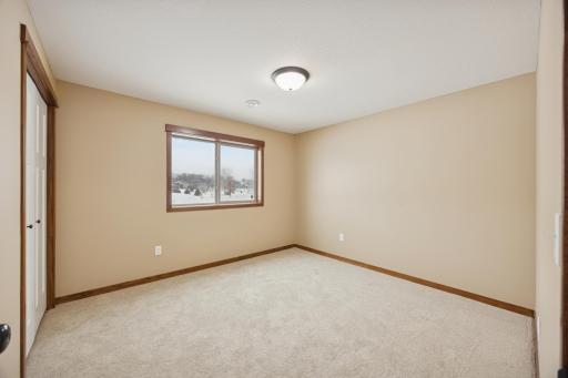 Versatile lower level 5th bedroom with clean finishes and natural lightâideal for a guest room or hobby space.